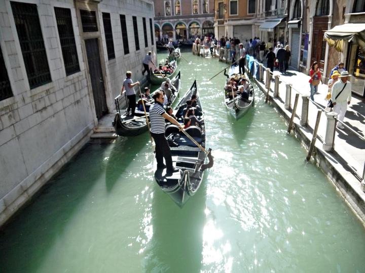 Gondolas in small canals venice italy jermpins